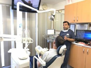 Dentist explaining about wisdom tooth extraction, and discussing risks