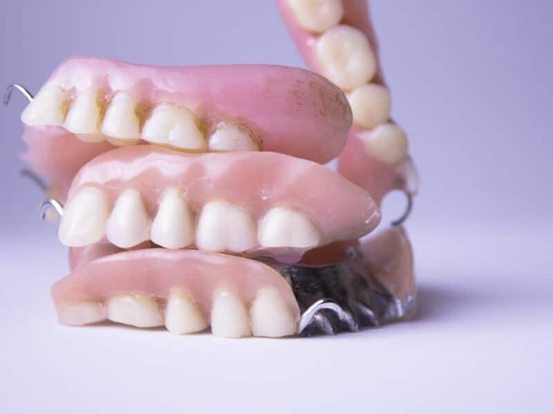 Several dentures in a pile for denture repairs Hamilton