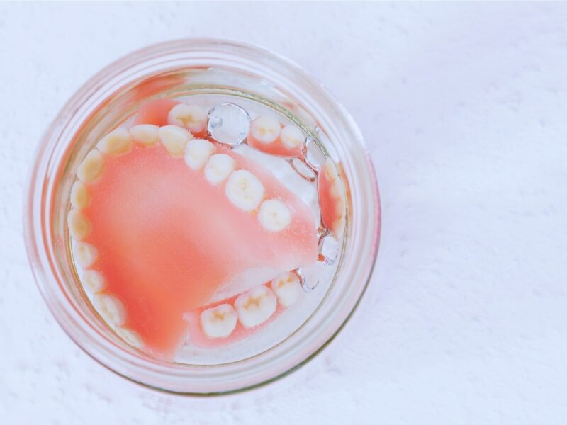 Dentures soaking in a glass, dentures and sleep