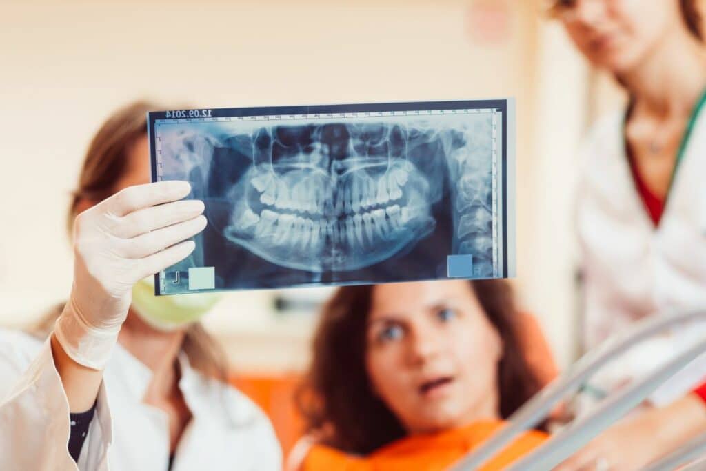dentist and patient looking at wisdom teeth Xray